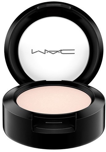 An open makeup compact with beige powder, black case, and a mirror with MAC logo inside.