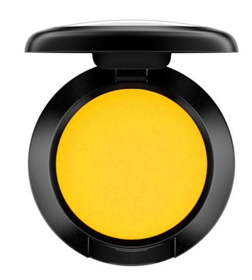 A compact round yellow makeup powder inside a black round case with a lid.