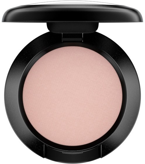 A compact makeup product with a light pink powder inside, open lid, black round case.