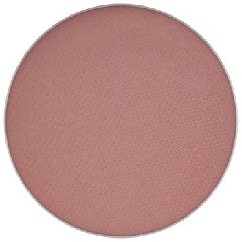 A round makeup blush in a soft pink shade.