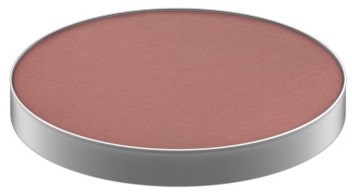 A round, flat makeup blush in soft pink color with a silver edge.