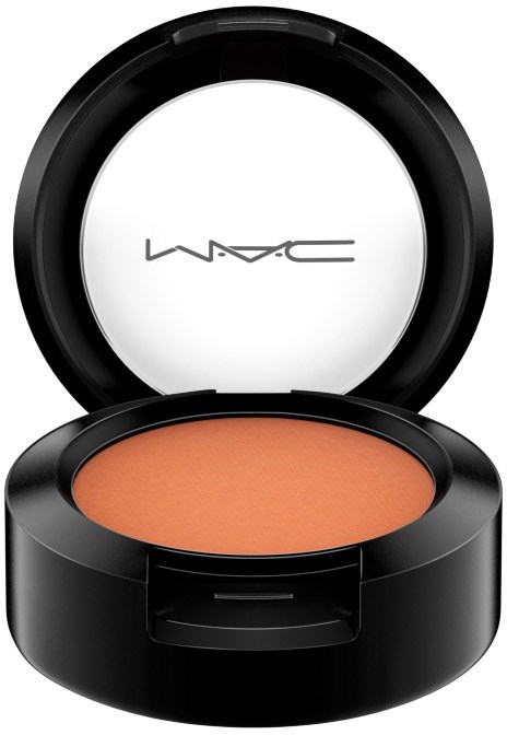 MAC blush in a black round compact with a white inside and logo, containing peach-colored makeup.