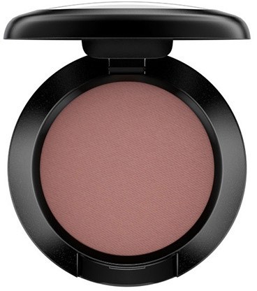 A compact makeup product with a closed black lid, revealing pinkish powder inside.