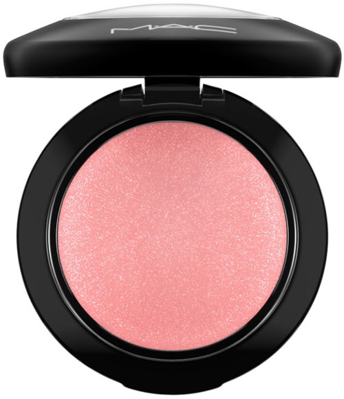 A round, pink makeup product with a black case and a tap-off lid, labeled with MAC. Singed with a glittery finish.