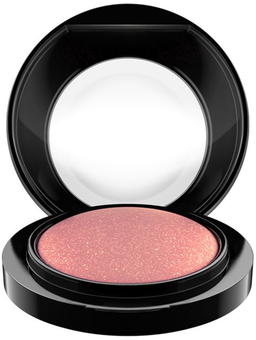 A round pink makeup blush with glitter, in an open black compact with mirror.