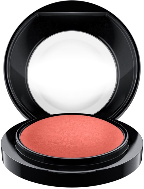 A round makeup blush in a black compact case with a clear lid.