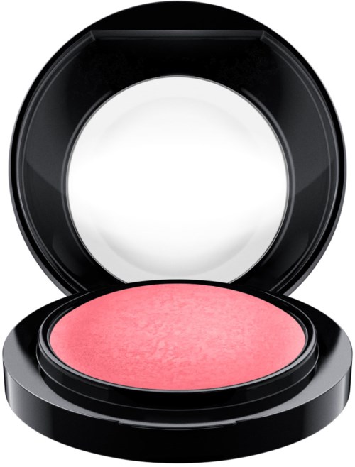 A round pink blush in an open black compact case with mirror inside the lid.
