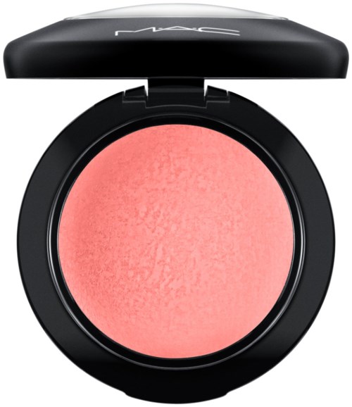 A round pink blush in a black compact case with a lid, brand logo on the lid.