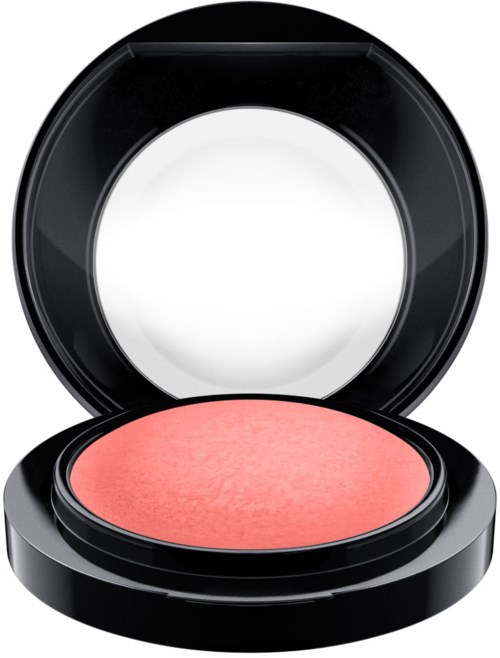A round blush compact with a pink shade inside, open with mirror reflecting light.