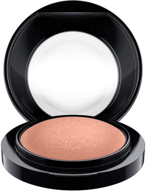 A compact with a peach-colored powder inside, and the lid open showing the mirror.