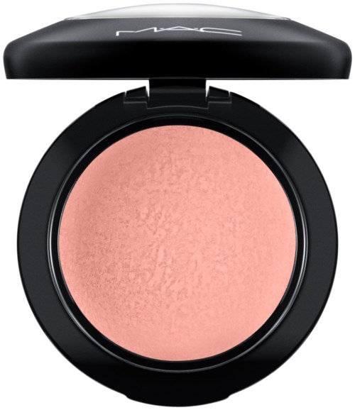 A round blush container with a black lid and pink blush inside.