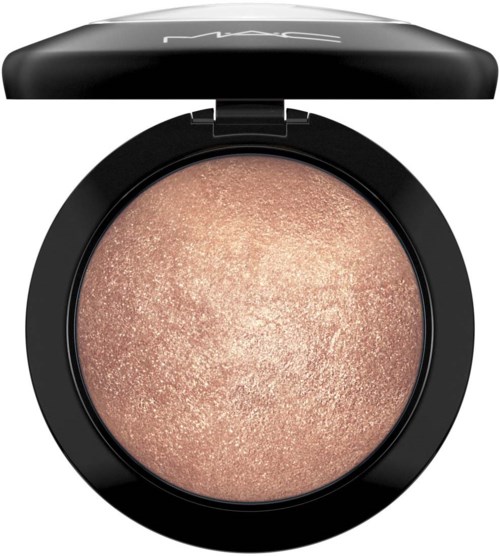 A round, open cosmetic compact with shimmery beige eyeshadow inside and a black lid. MAC logo on the lid.