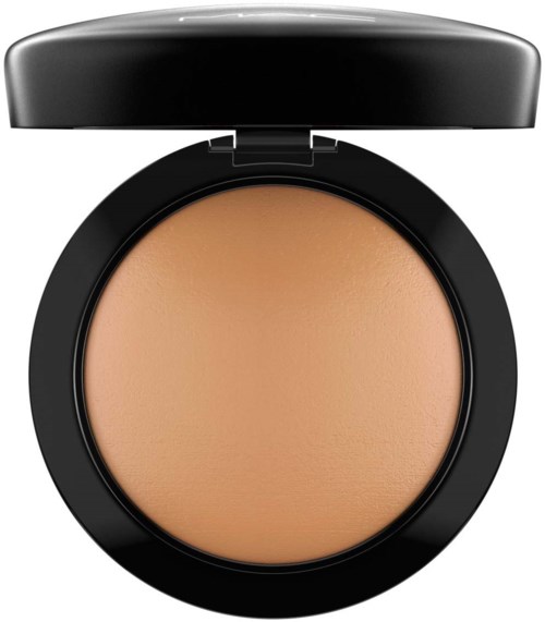 A compact with beige powder inside and a black lid on top.