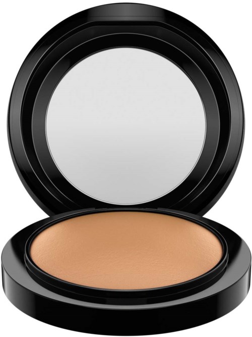 A compact with pressed powder inside, black round case, open, showing beige makeup surface.