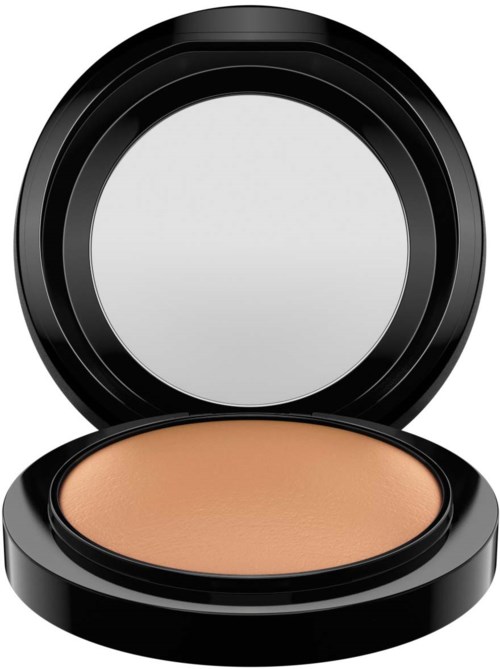 A round compact with beige powder and a black lid, open to show the makeup inside.