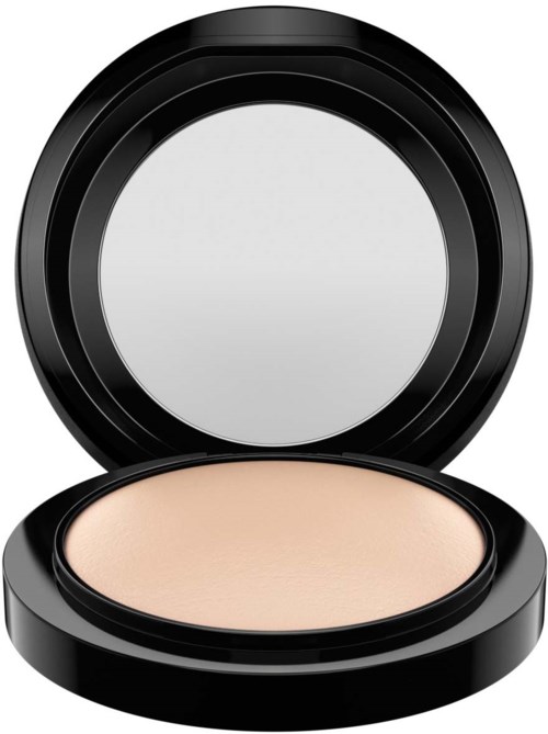 A compact with beige powder inside, and a round mirror on the inside of the lid.