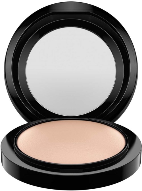A round compact with a mirror and beige powder inside.