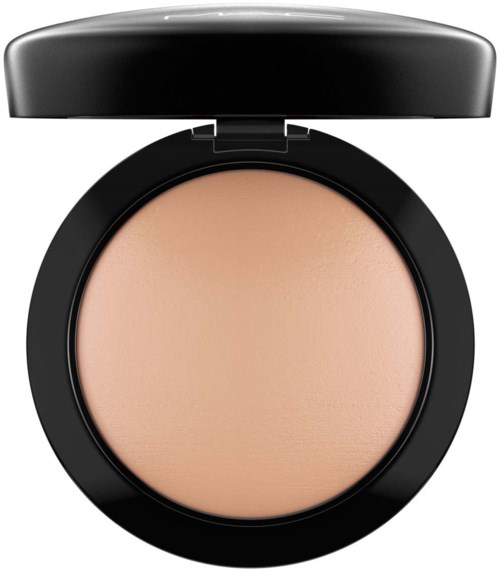 A round compact with beige powder inside and a black lid on top.