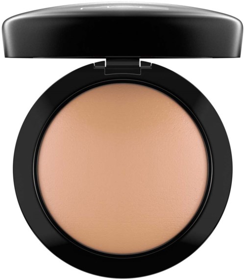 A round compact with a lid, containing beige pressed powder used for makeup.