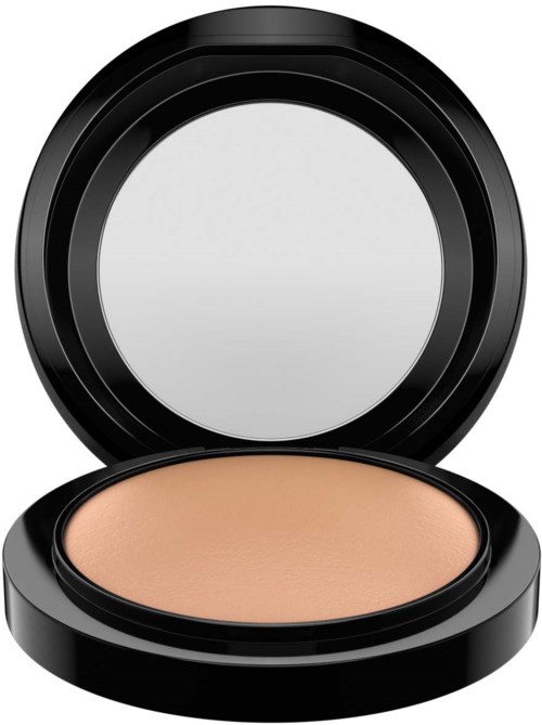A compact with a mirror on the lid and beige powder inside.