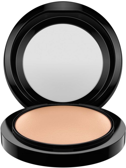 A compact with light beige powder inside, black round case, open lid with mirror, used for makeup.