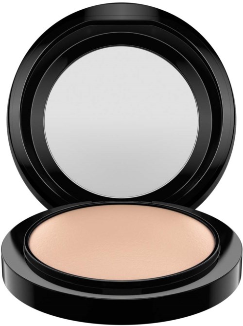 A compact with beige pressed powder and a mirror inside the lid.