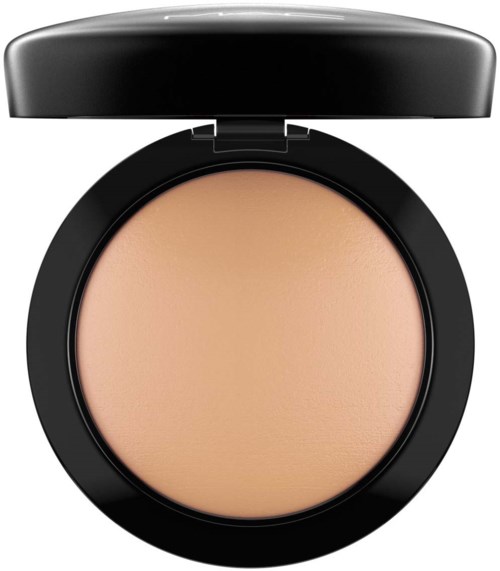 A compact powder case with beige pressed powder inside and a black round lid.