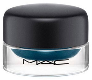 En liten burk med MAC kosmetika med mörkgrått lock, genomskinlig behållare och blå vågmönster.