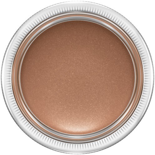 A round container with beige makeup or cream inside, viewed from the top.