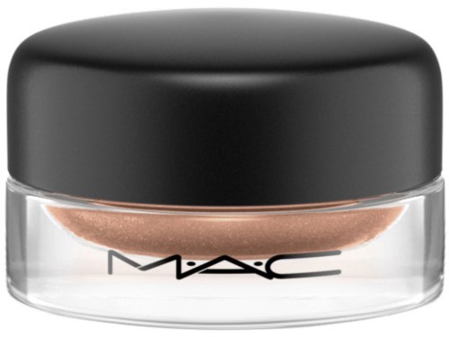 A small transparent jar with a black lid, filled with shiny beige or champagne-colored powder makeup.