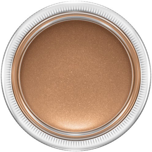 En rund behållare med beige, glänsande kräm eller makeup inuti. Silver och vita kanter på behållaren.