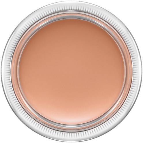 A round jar with a white lid, filled with peach-colored creamy makeup.