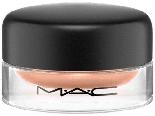 A small round container with a black lid and clear base, containing beige makeup product from MAC.