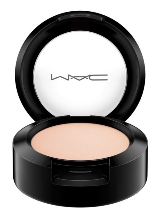 A black round container with a mirror inside, holding light-colored makeup powder.