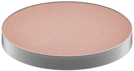 A round makeup blush pan with a peach color and a textured surface.