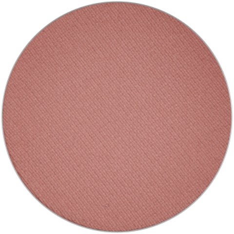 A round makeup blush with a soft pink color and textured surface.