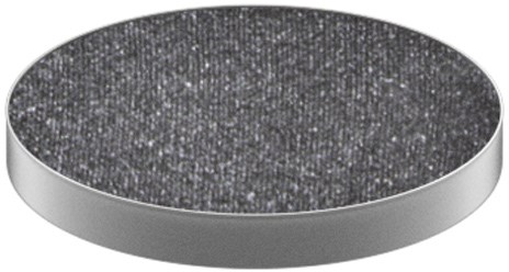 A round, gray object with a dark, rough textured top surface and smooth edge.