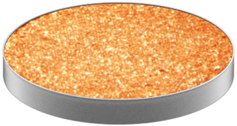Round object with a gold, glittery surface and a gray edge.