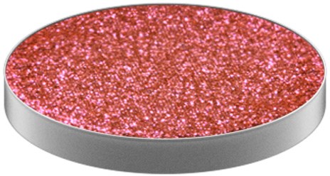 Ett runt objekt med en ljus rosa, glittrig yta i ett silverram.