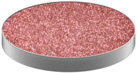 A pink, glittery eyeshadow in a round silver container. Sparkling and shiny surface. Beauty product.
