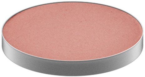 A round, flat object with a pink, textured top and a silver edge.