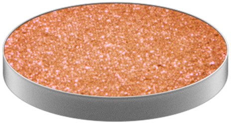 En rund, glittrig, orange yta med en grå kant, liknande en glittrig makeup- eller hantverksprodukt.