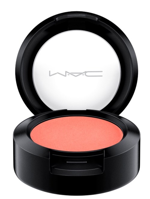 A round black compact with pink blush inside and a mirror on the lid. The brand MAC is written inside the mirror.