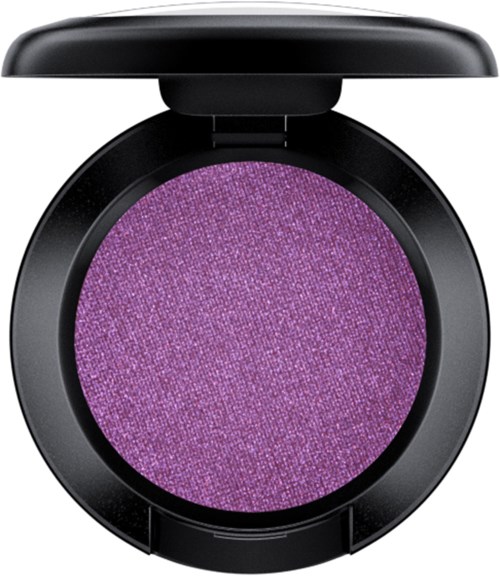 A purple eyeshadow in a round black compact with a lid open.