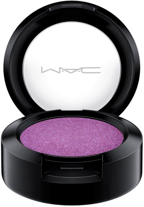 A round cosmetic compact with purple eyeshadow inside and a mirror on top.