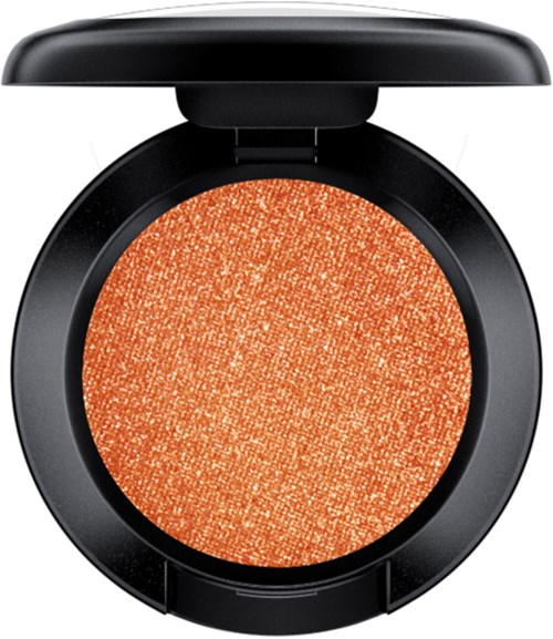 A black round compact with orange glitter eyeshadow inside and a lid open.