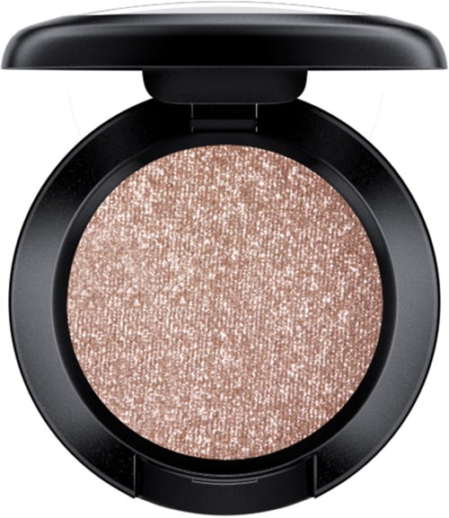 A round makeup compact with a shimmery, beige eyeshadow or highlighter inside, black outer case, and open lid.
