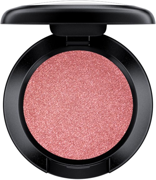 A round makeup blush with a pinkish, sparkly surface in a black container.