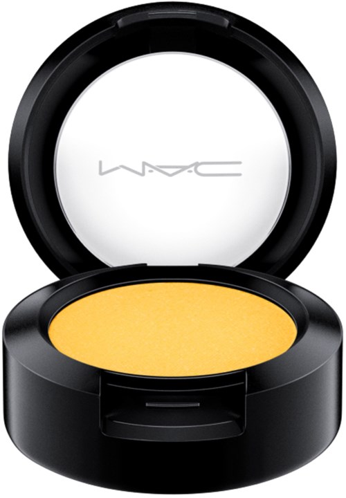 A round makeup compact with yellow eye shadow inside and a white MAC logo on the inside of the lid.