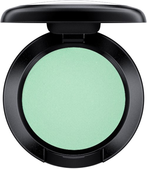 A compact round green eyeshadow in a black case with a lid open.